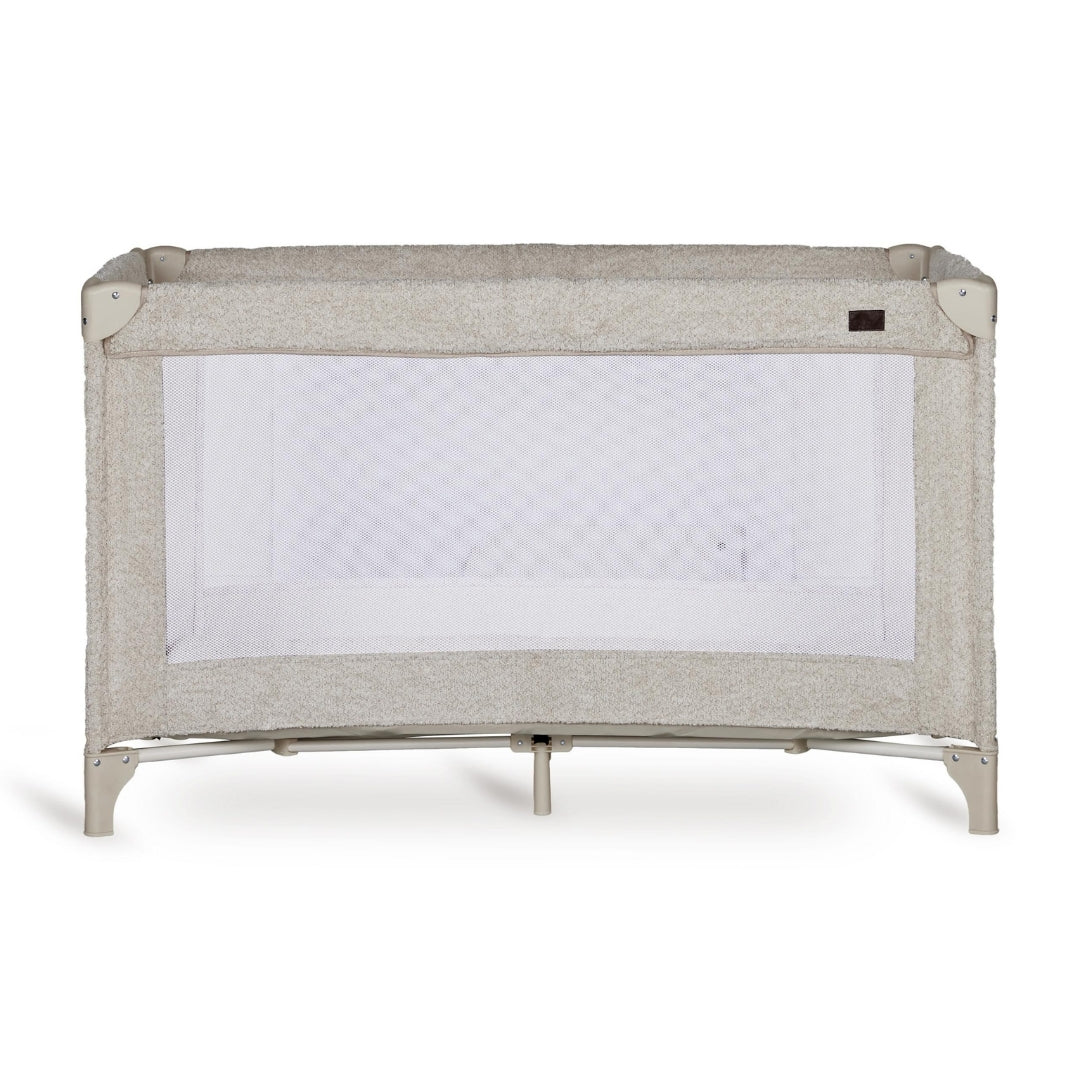 Quax travel cot with soft sheep boucle fabric head on view on plain white background