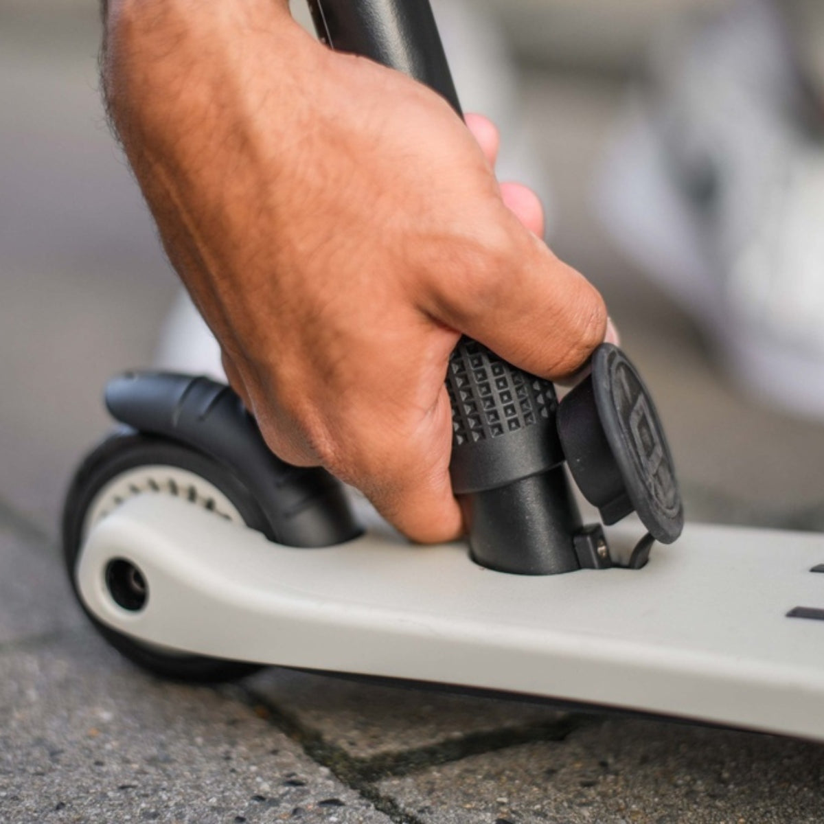 close up of push handle being fitted by adult to scoot and ride highwaykick1 scooter ash