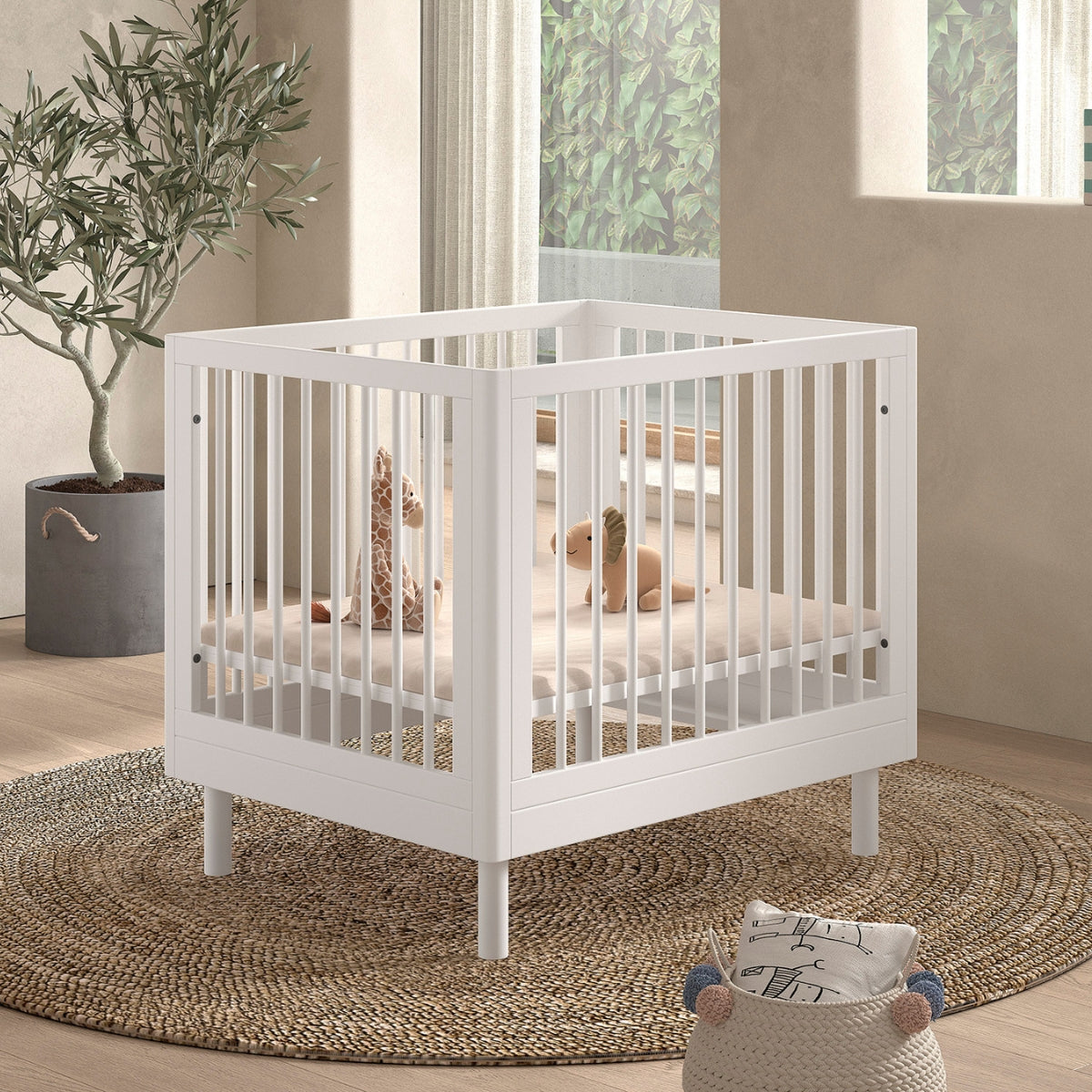 VIPACK JAXX baby playpen white with a cushion and soft toys in a modern looking UK nursery room  