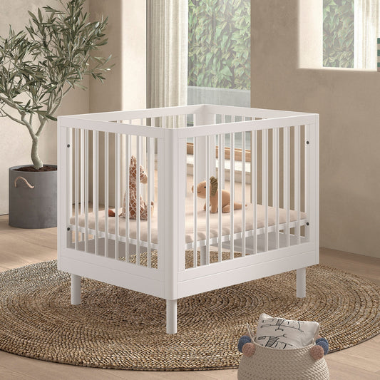 VIPACK JAXX baby playpen white with a cushion and soft toys in a modern looking UK nursery room  