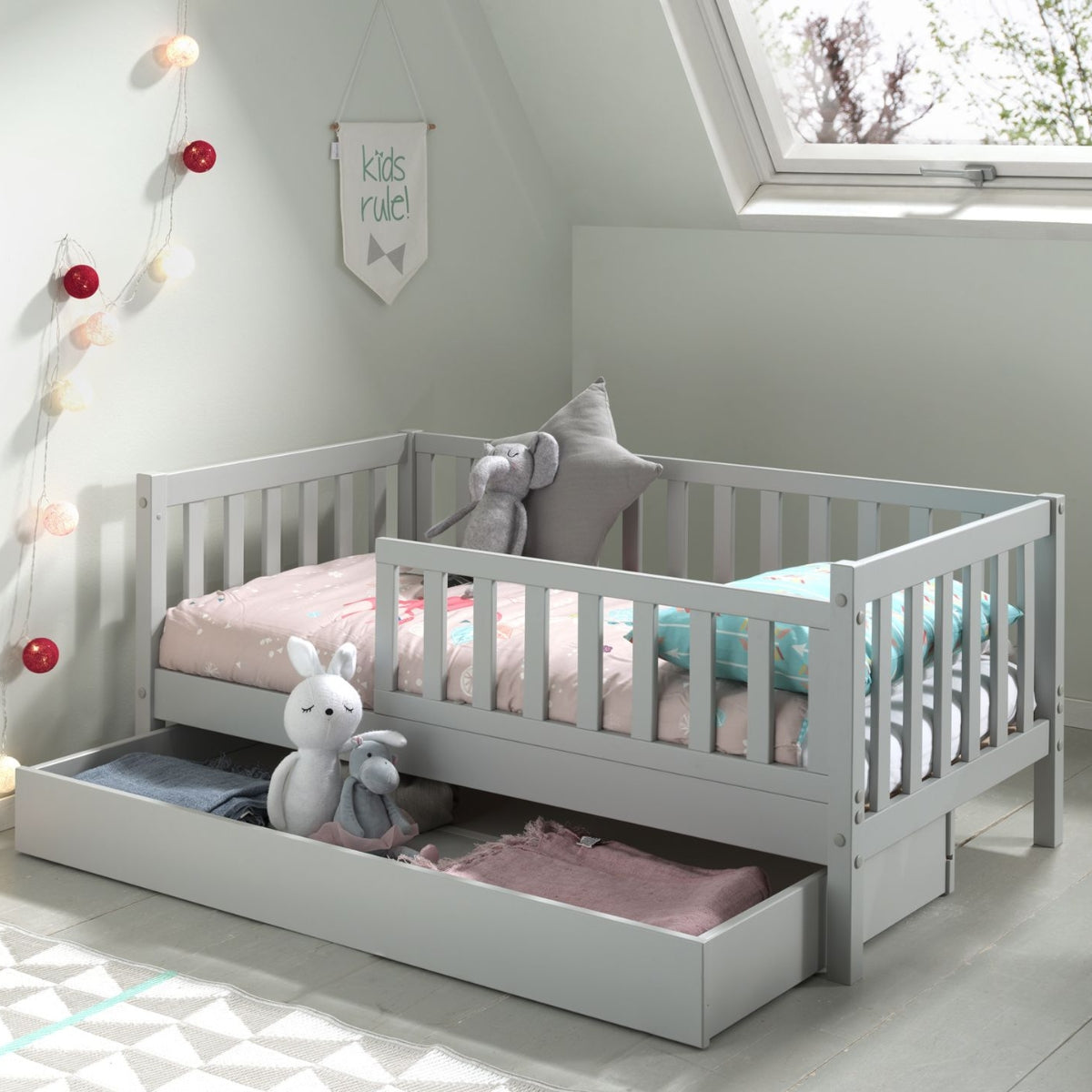 vipack toddler bed with underbed open underbed storage drawer full of toys and blankets